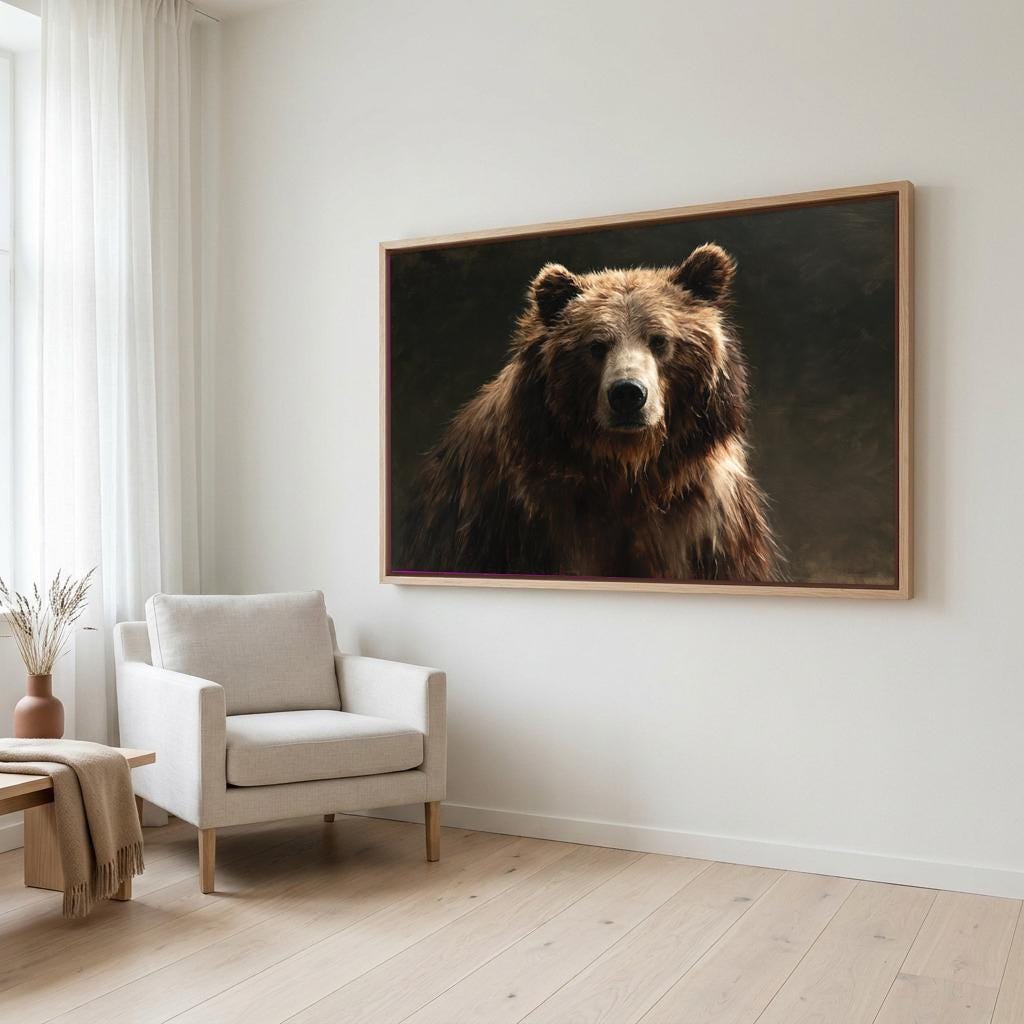 a large, framed painting of a brown bear on a white wall in a living room setting.