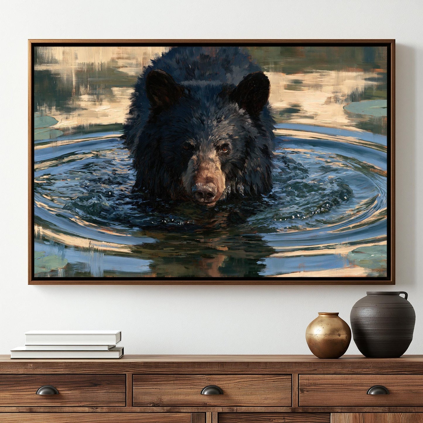A framed painting of a black bear swimming in a body of water, with a wooden dresser below it.