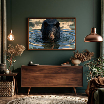 a large black bear swimming in a body of water, with a framed photograph of the bear hanging on the wall above a wooden dresser.