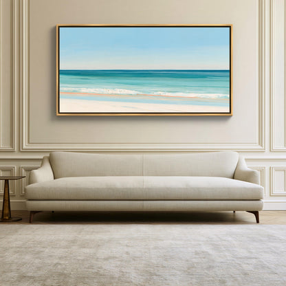 Turquoise ocean beach canvas wall art, large, framed painting of a beach scene hanging on a wall above a beige sofa in a