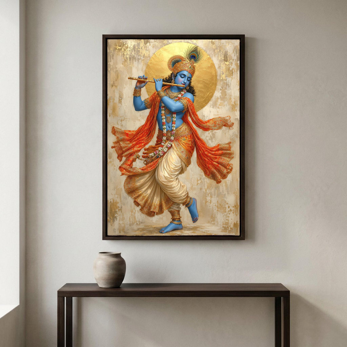 a framed painting of a Hindu deity, specifically the Hindu deity Krishna, playing a flute. The painting is hanging on a wall above a small table with a vase on it.