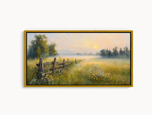 A framed painting depicting a serene countryside landscape with a wooden fence, lush green grass, and trees in the distance under a hazy, golden sky.
