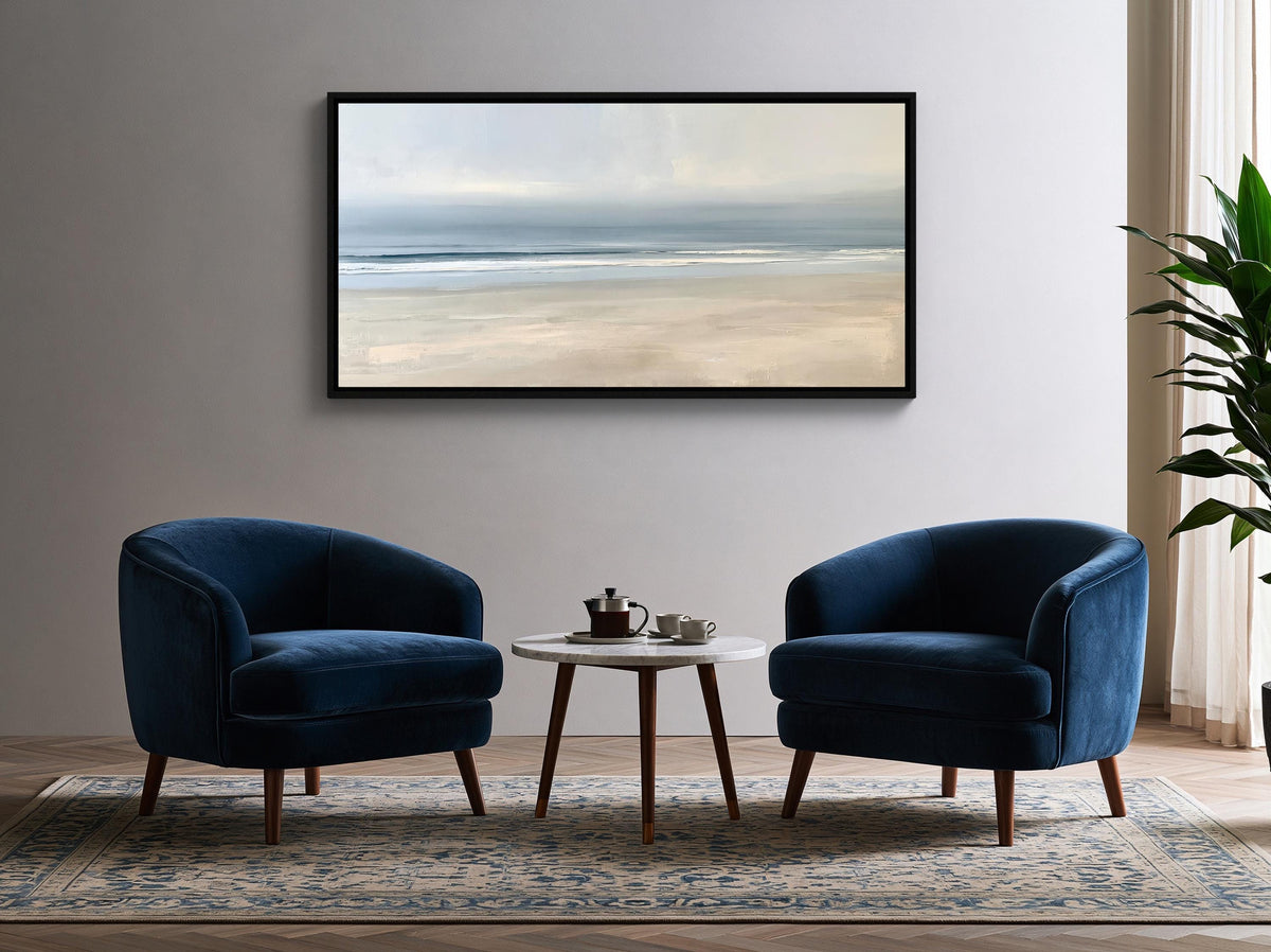 Calm minimalist beach canvas wall art, living room with two blue armchairs and a small round table, positioned in front of a