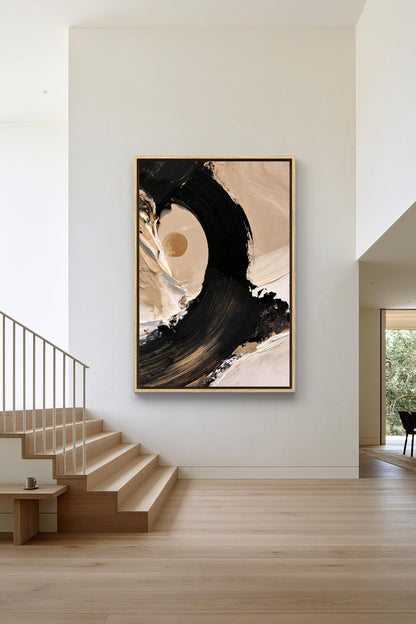 Black brush stroke sun canvas wall art, large abstract painting hanging on a white wall above a set of wooden stairs