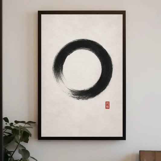 a framed artwork of a black circle with a red square symbol in the bottom right corner.