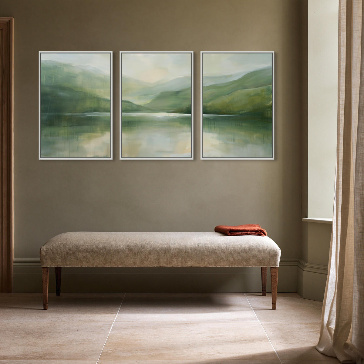 Misty sage lake triptych canvas wall art, serene and minimalist interior design with a beige bench and a framed landscape