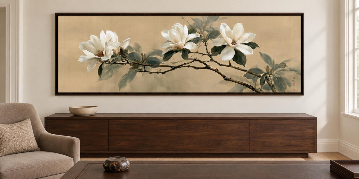 a large painting of white flowers on a branch hanging on a wall above a wooden cabinet or dresser in a living room.