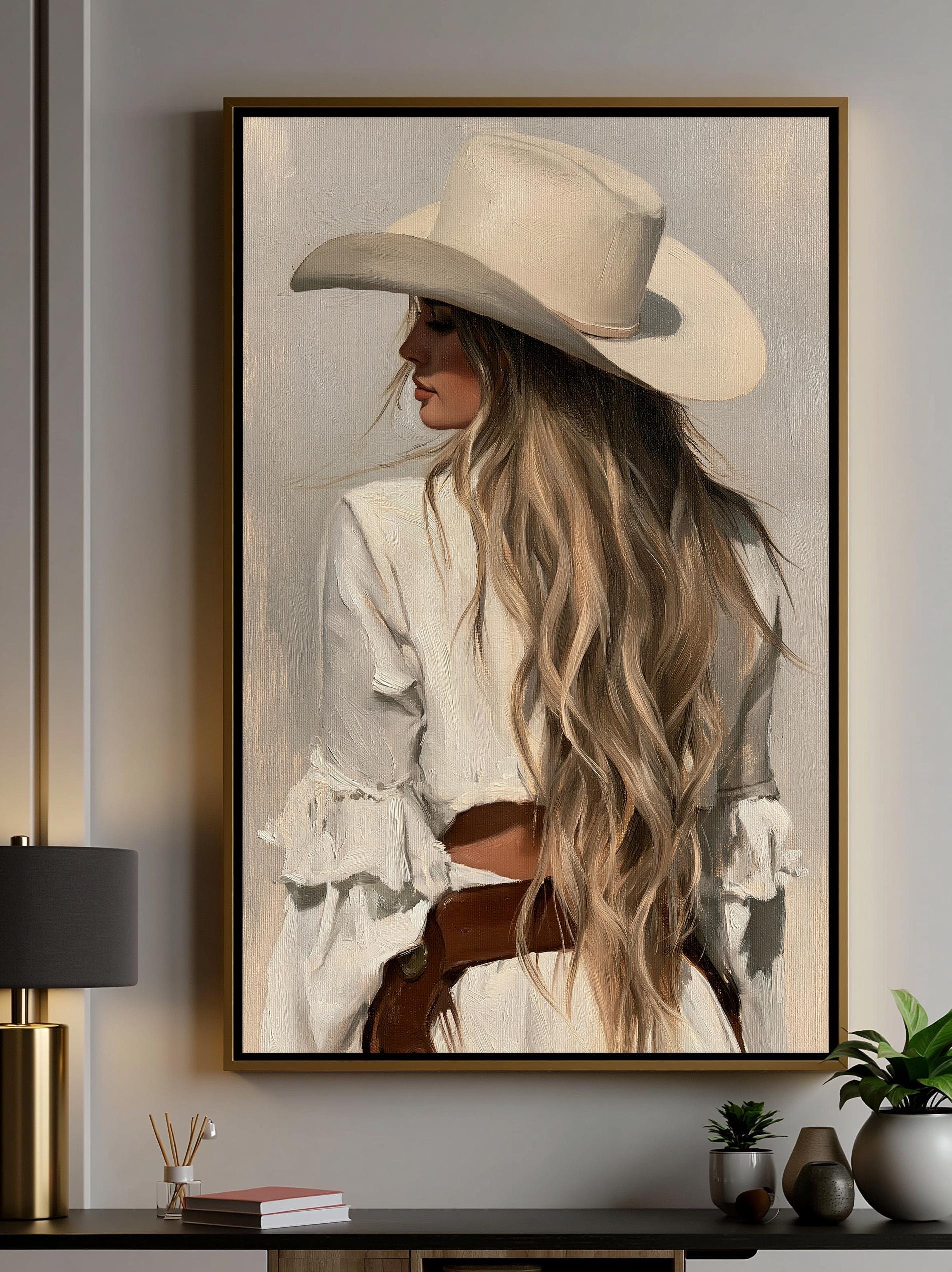 A framed painting of a woman with long, flowing blonde hair wearing a white hat, standing against a neutral background.