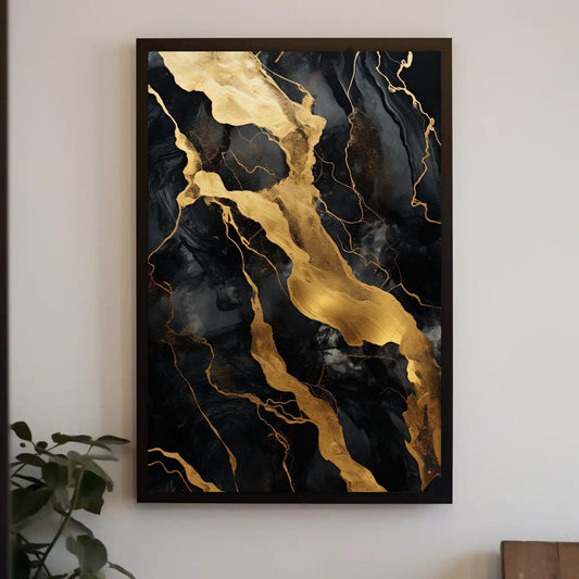 a black and gold painting hanging on a wall