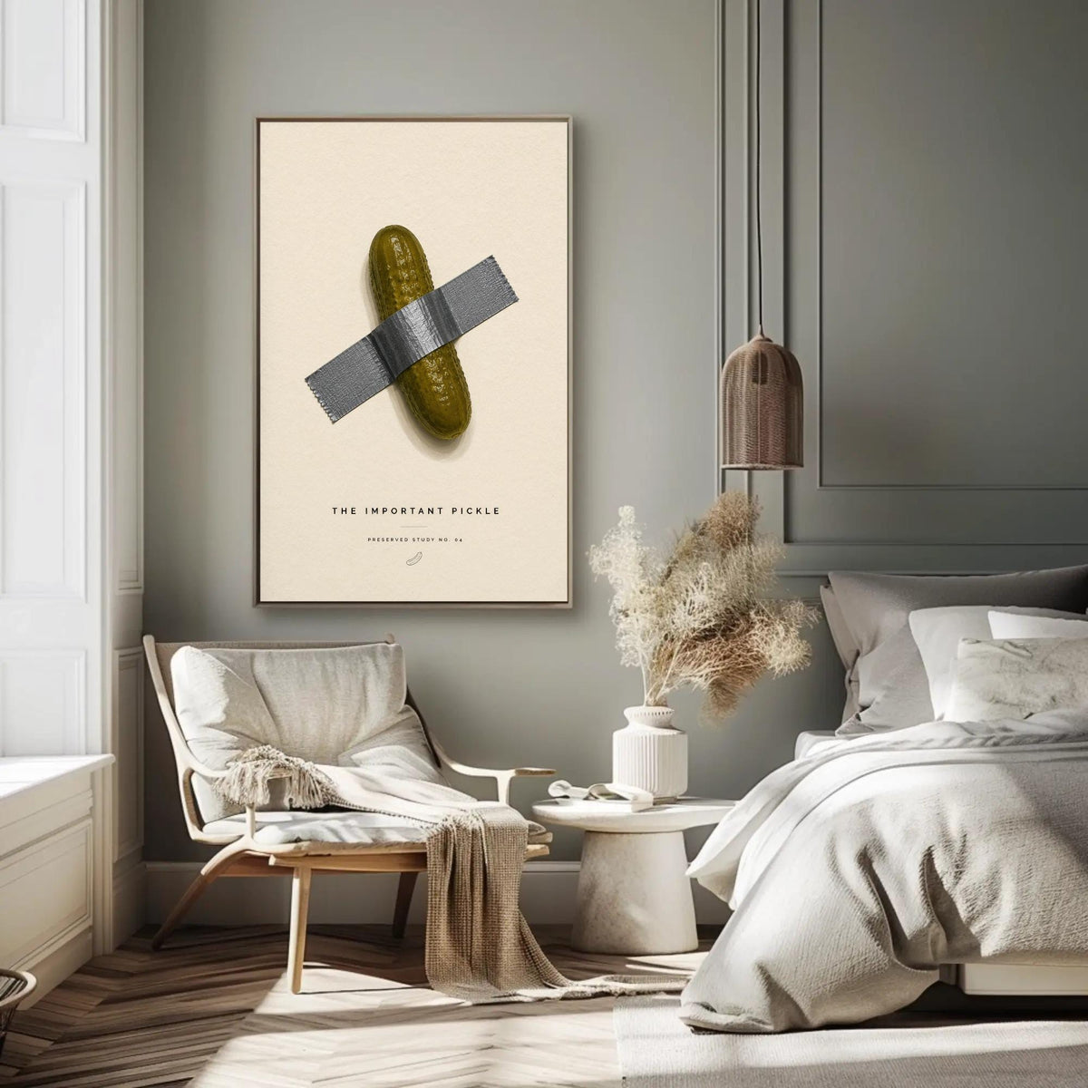 Taped pickle canvas wall art, bedroom with a bed, a chair, a table, and a poster on the wall. The poster features a picture