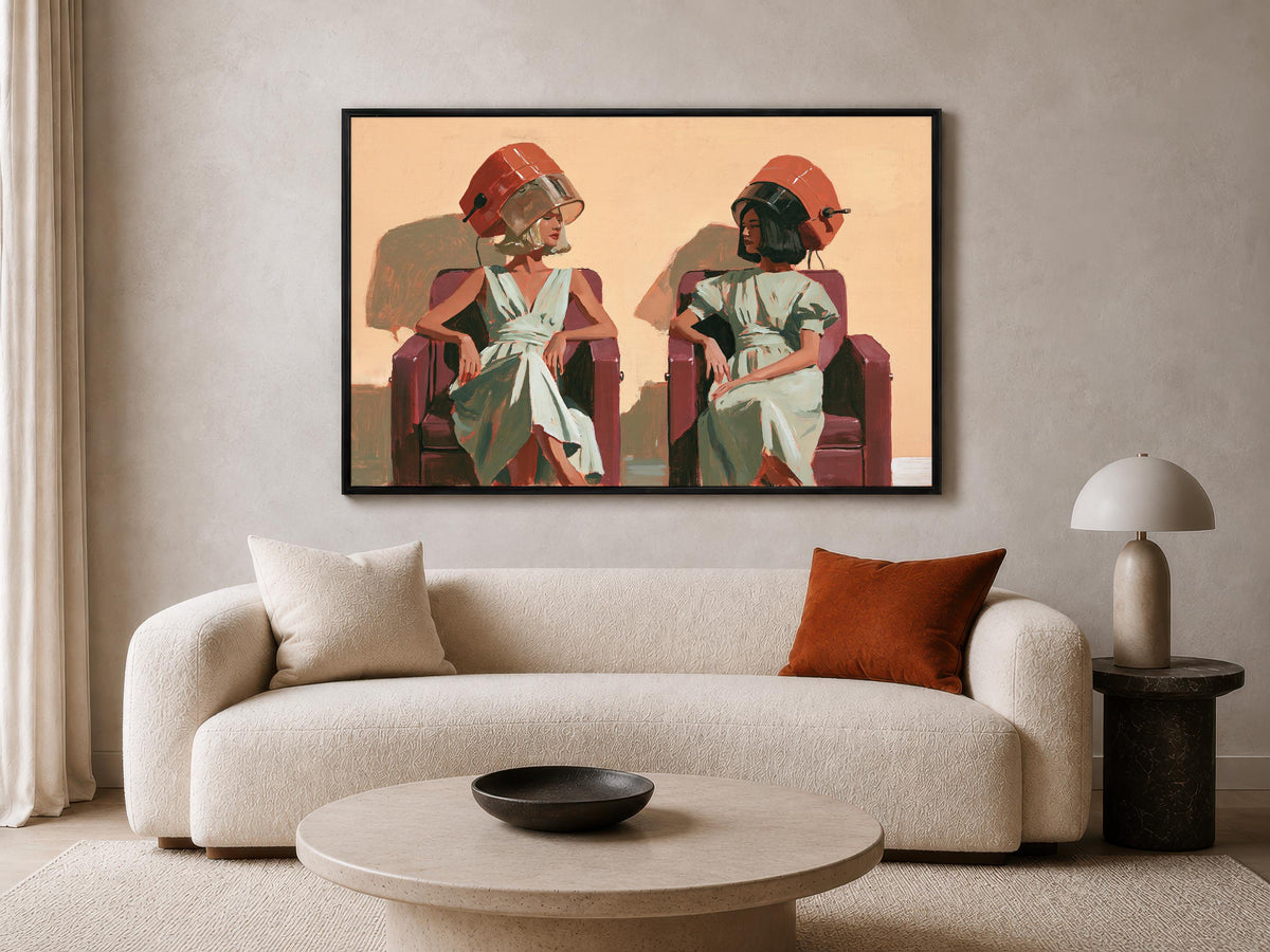 a large framed painting of two women sitting in chairs, with one woman wearing a red hat and the other wearing a green hat. The painting is displayed on a wall above a beige sofa and a round coffee table.