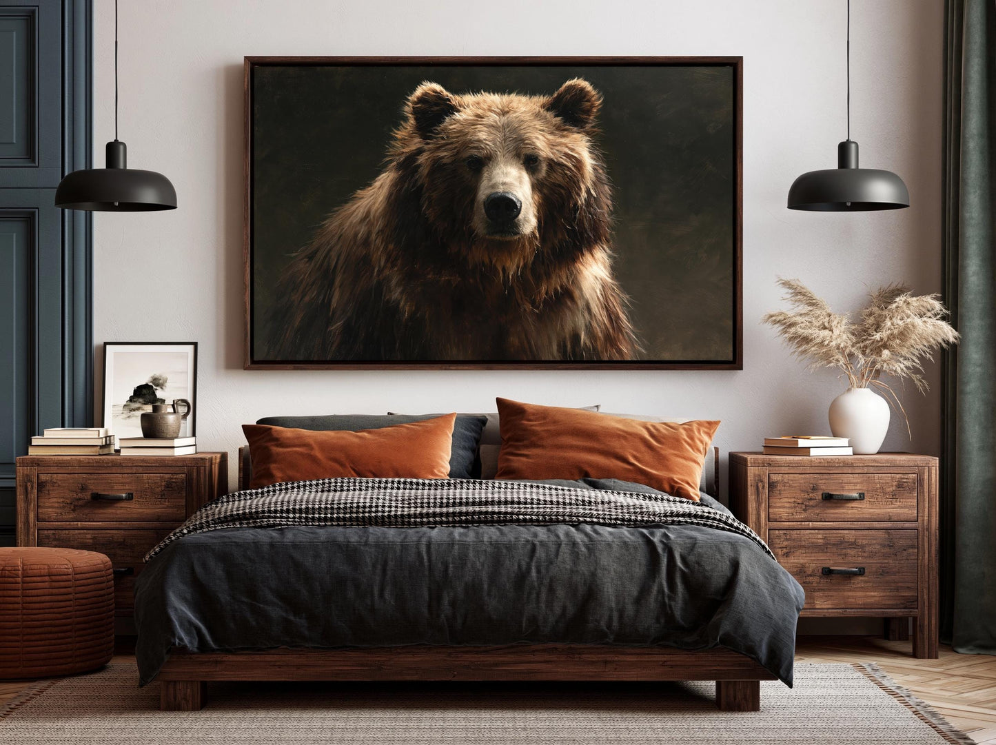 a large, dark brown bear in a portrait-style photograph, which is prominently displayed on the wall above a bed with a black and gray bedspread.