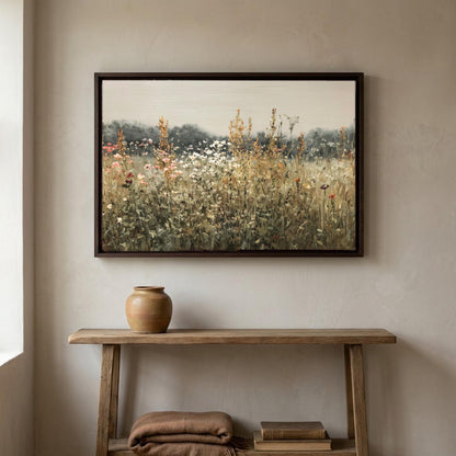 Sage wildflower meadow canvas wall art, wooden console table with a vase on top, and a framed painting of a field of flowers