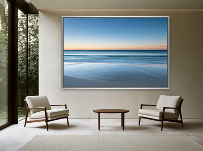 Ocean horizon at dusk canvas wall art, serene beach scene with a large framed picture hanging on the wall, depicting a