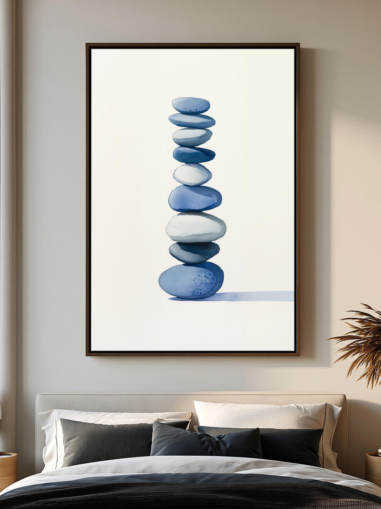 a large framed picture of blue and white stones on a wall above a bed with white pillows and a black comforter.