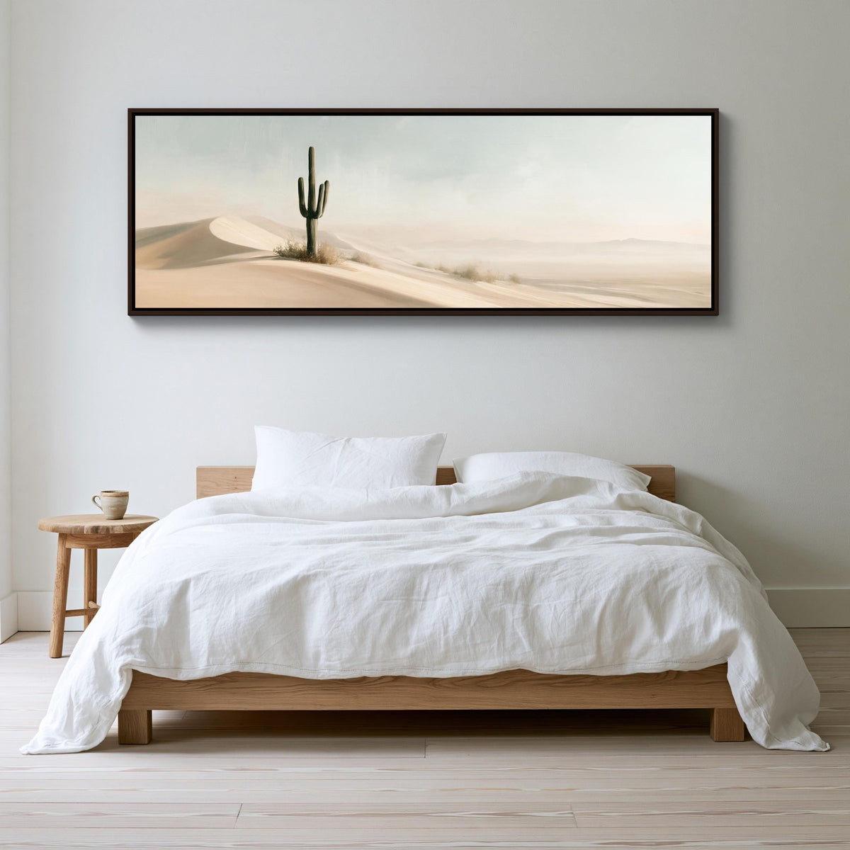 Lone saguaro on sand dunes canvas wall art, serene bedroom scene with a large bed, a nightstand, and a framed landscape