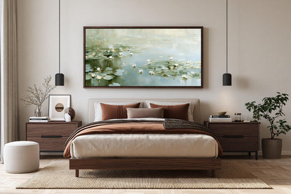 a serene bedroom with a large bed, wooden furniture, and a framed painting of water lilies hanging above it.