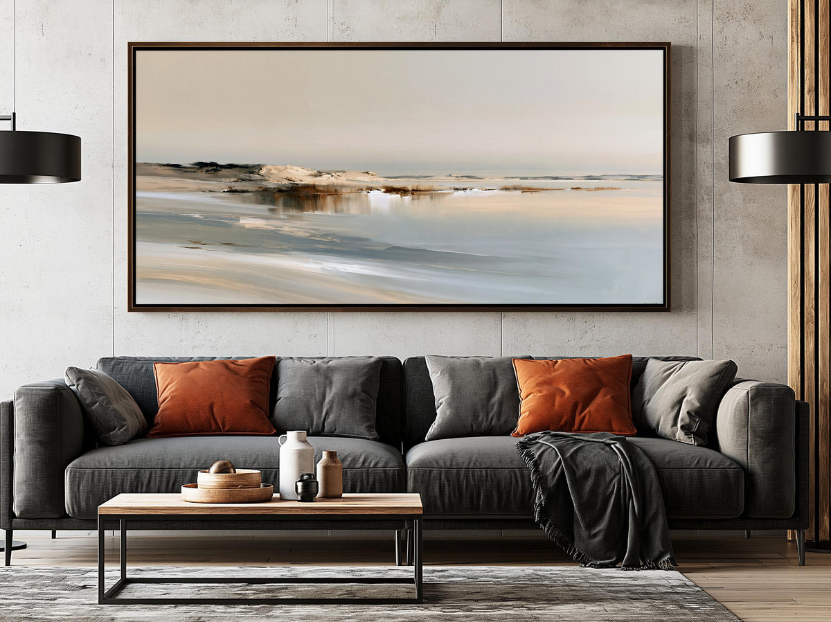 a modern living room with a gray sofa, a wooden coffee table, and a large framed landscape painting hanging on the wall above the sofa.
