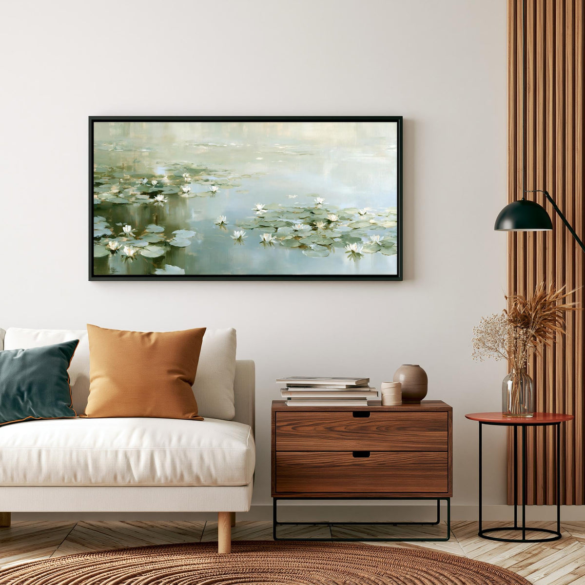 a living room with a white sofa, a wooden side table, and a framed painting of water lilies hanging on the wall above the sofa.