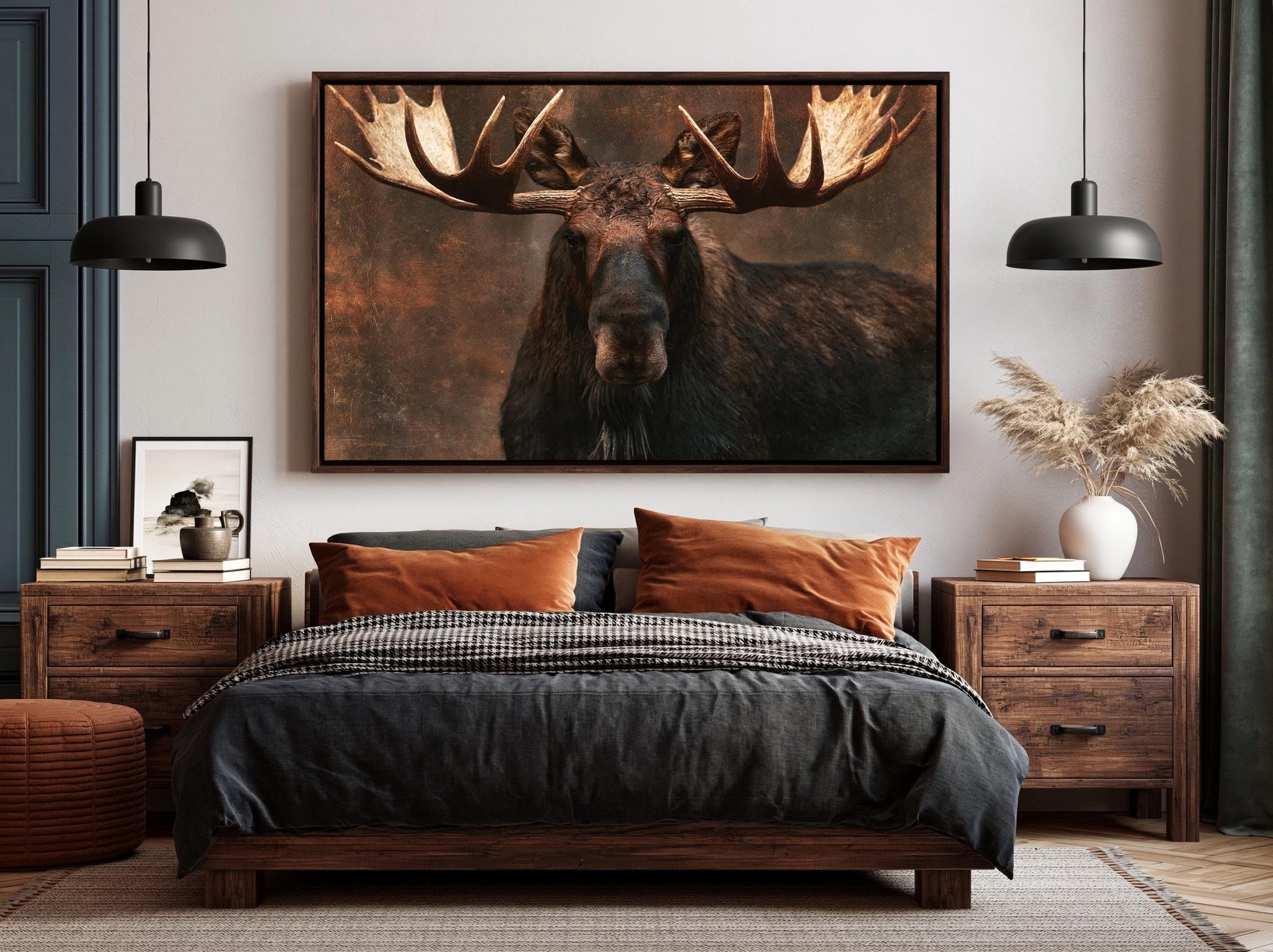 a large framed picture of a moose with large antlers hanging above a bed in a bedroom setting.