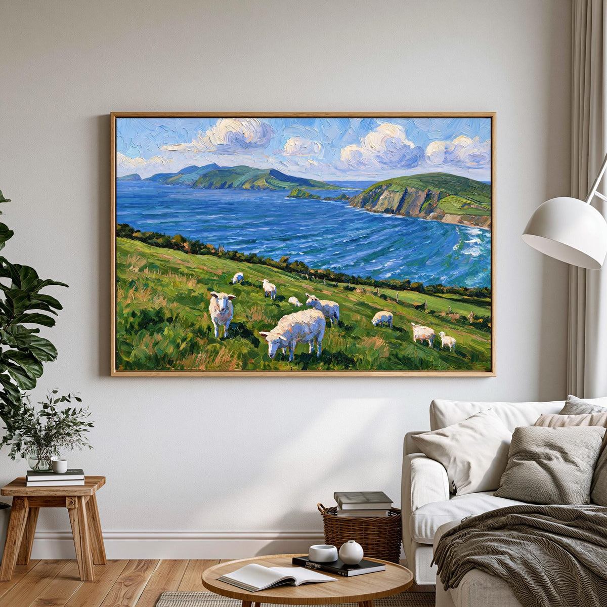 a pastoral scene with a group of sheep grazing on a grassy hill overlooking a body of water, with mountains in the background.