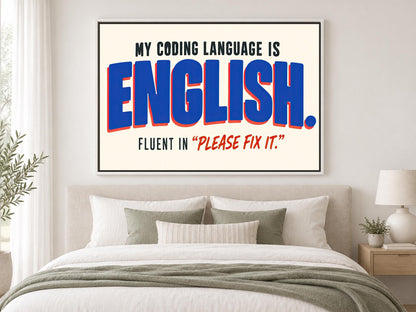 a bedroom with a large framed poster on the wall that reads "MY CODING LANGUAGE IS ENGLISH. FLUENT IN "PLEASE FIX IT"".